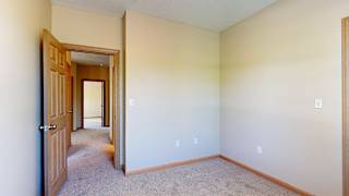 a bedroom with a door to a hallway