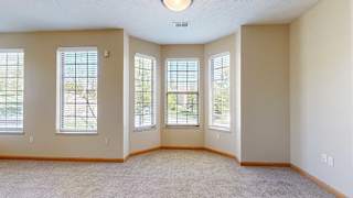 a living room with a bay window dining space