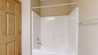 a bathroom with a shower and a bath tub