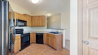 a kitchen with black appliances and wooden cabinets