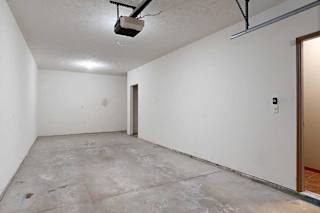 A tandem 2-car garage with under-stair storage.