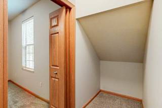 A walk-in closet with an angled ceiling.