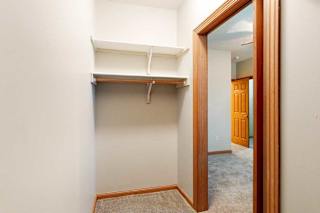 A walk-in closet with built-in shelves.
