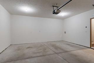 A 2-car attached garage with over head lights, and a door to the apartment.