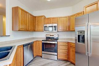 A kitchen with wooden cabinets and stainless steel appliances.