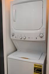Stacked washer and dryer unit in a closet
