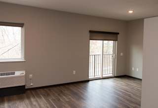 Studio living space with window and sliding glass door