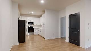 a modern kitchen with light cabinets and stainless steel appliances next to a dining area