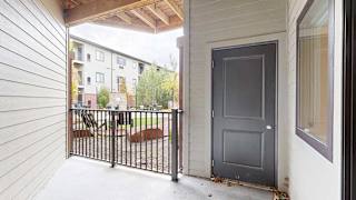 an elevated patio overlooking the courtyard with a door to the outdoor storage space