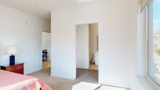 a bedroom with a bed and a mirror
