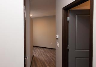Entryway of studio apartment with bathroom door to the right