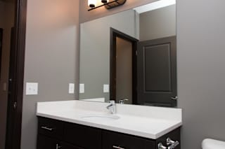 A bathroom with a white sink and a mirror above it.
