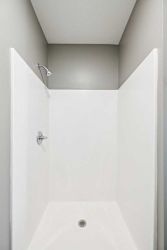 A white walk in shower insert.