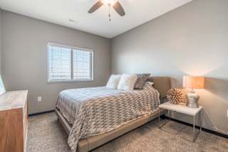 Living room with ceiling fan at The Flats at 84 in southeast Lincoln NE 68516
