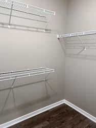 Walk-in closet with shelving and rods in the Plum studio apartment