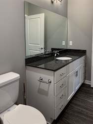 Bathroom with large white vanity and mirror in the buffalo floorplan