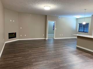 Large living and dining area with hardwood floors