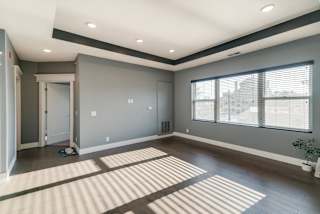 Living room with wide window and dark brown wood floors