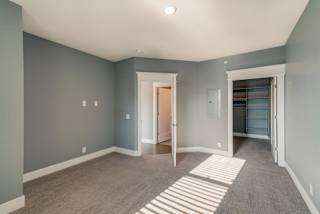 A room with a striped rug on the floor.