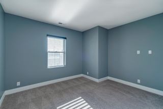 A room with a window and a carpeted floor.