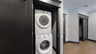 a front load washer and dryer in a laundry closet