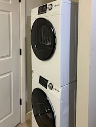 a front load washer and dryer in a laundry room