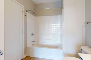 A bathroom with a tub shower.