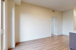 A living room with wooden floors and white walls.