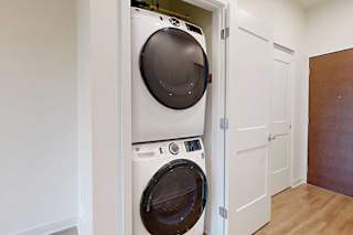 Stacked front loading washer and dryer in a closet