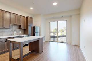 A kitchen with warm brown cabinets and a moveable island.
