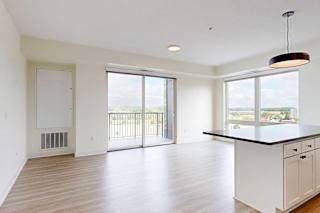 A spacious kitchen with white cabinets and a large island.