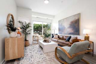Furnished living room with walk out balcony access
