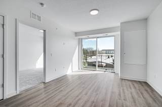Spacious and bright dining and living area with balcony entry at The Rowan in Eagan Minnesota
