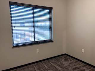 Carpeted den with window at the villas at mahoney park