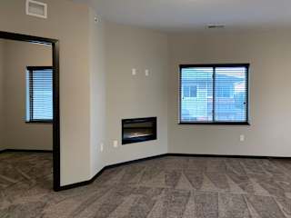 Living room connected to the den at the villas at mahoney park