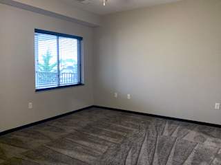 Large carpeted master bedroom at the villas at mahoney park