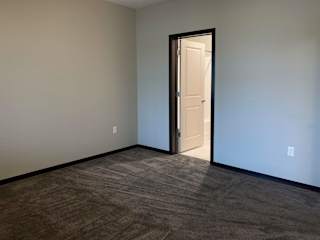 Large carpeted master bedroom at the villas at mahoney park