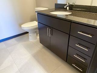 Bathroom vanity in the espresso finish of the acadia floorplan