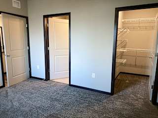 master bedroom with access to walk in closet and private bathroom