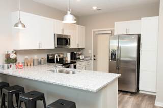white cabinet kitchen with bar stool seating