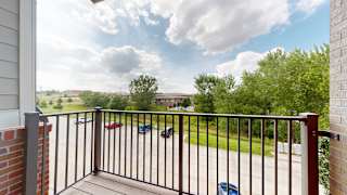 a balcony with a view of the community and clubhouse