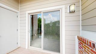 the sliding glass door to the living room from the balcony