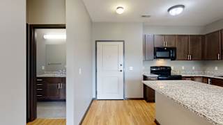 the front door leading into the entryway and kitchen space