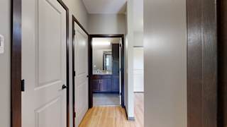 a hallways with doors to the bathroom, laundry room, and closet