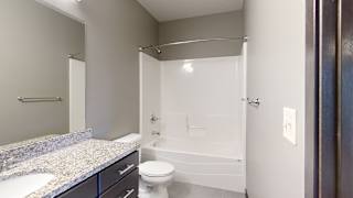 a bathroom with a shower tub combo and toilet and sink