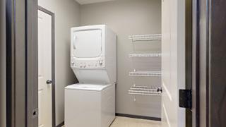 laundry room with a stacked washer and dryer