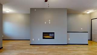 a living room with a fireplace and hardwood floors