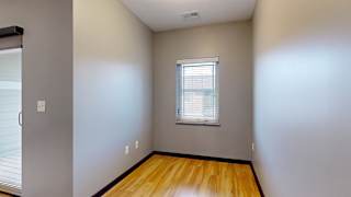 a unique nook with hardwood floors and a small window
