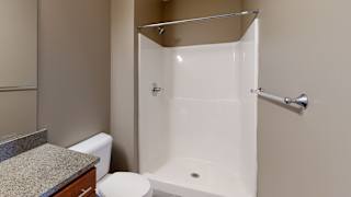 a walk in shower in the primary bathroom