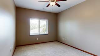 a bedroom with a ceiling fan and a window